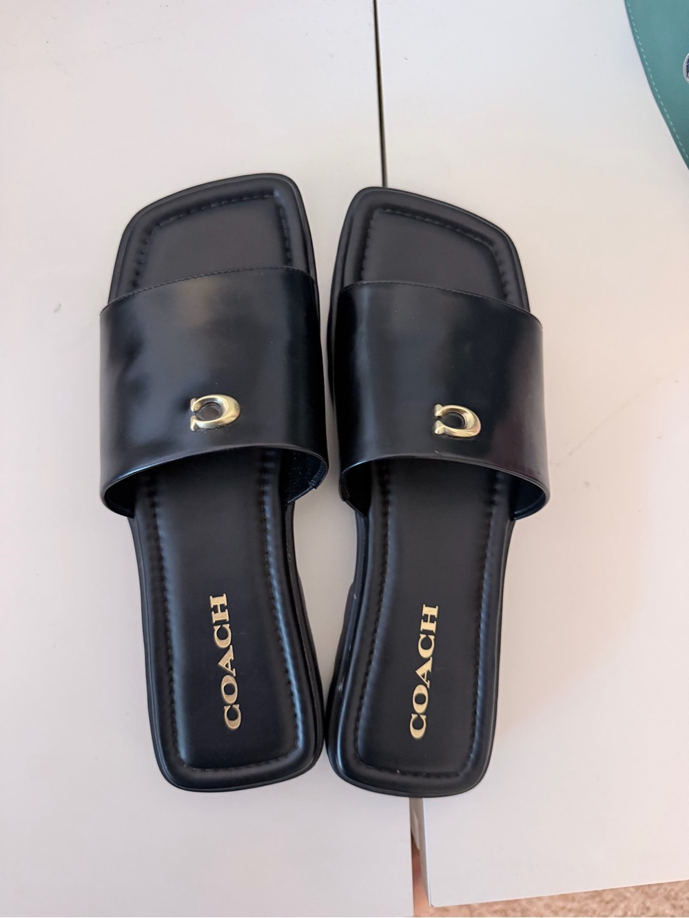 Coach Black Leather Slide Mules with Gold Logo Accent